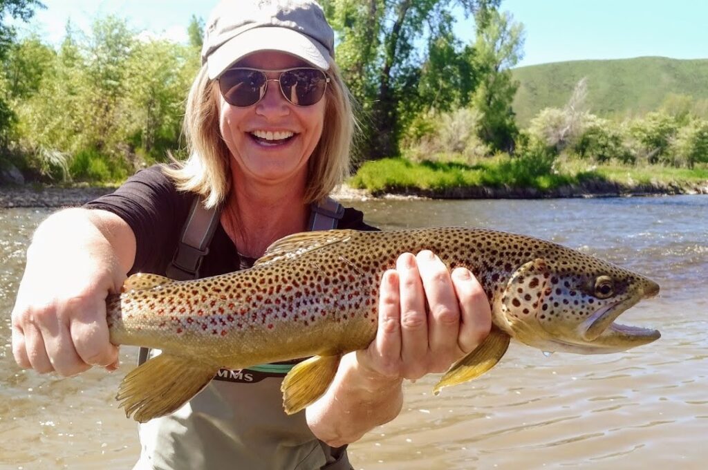 Woman holding a large Brown Trout